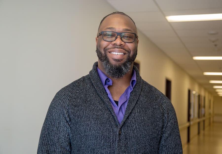 Andre Holness stands in a hospital hallway