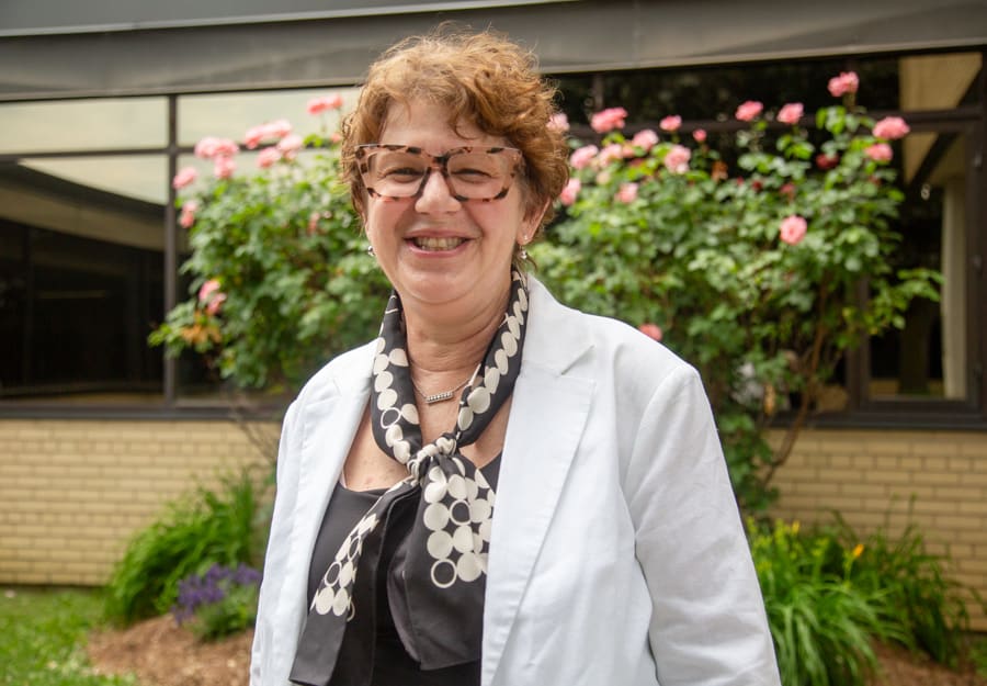 Nurse Practitioner Charmaine Martin-Gaspar stands in front of a rose bush at the Niagara Falls Hospital