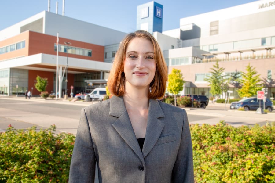 Dr. Franziska Miller stands outside with the Marotta Family Hospital in the background