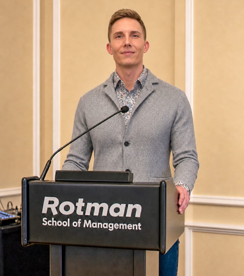 James Hall stands at a Rotman School of Management Podium