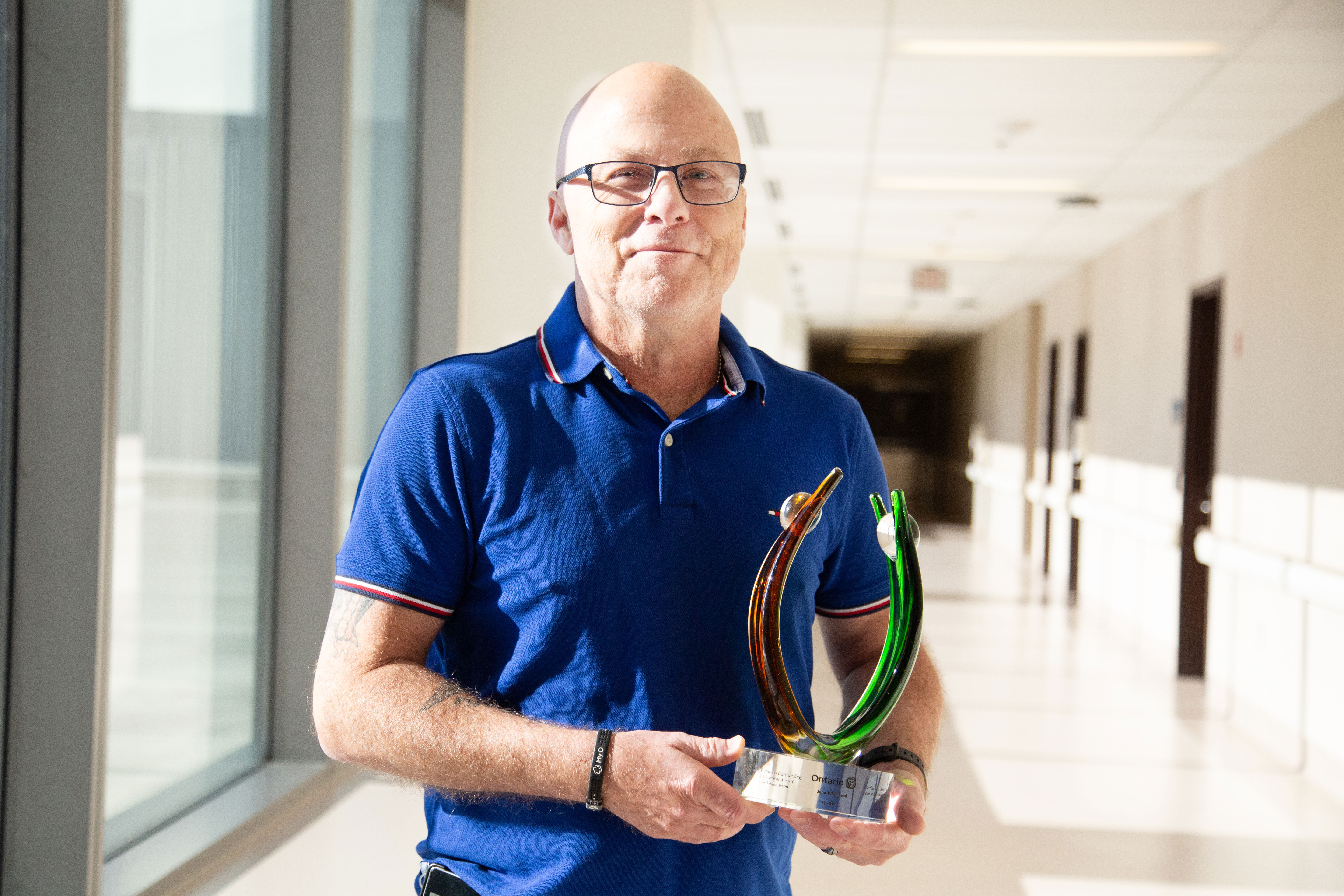 John Whitehead with his June Callwood Award in a hospital hallway