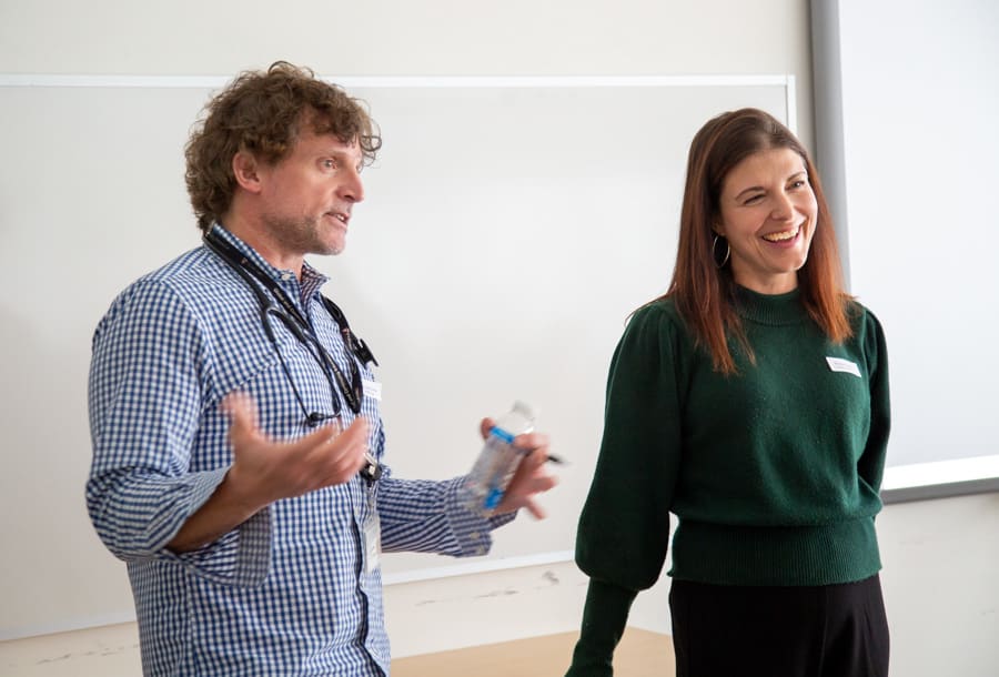 Dr. Danny Lagrotteria and Krista Connor speak to students during the Kidney Fair. They are standing at the front of a classroom.