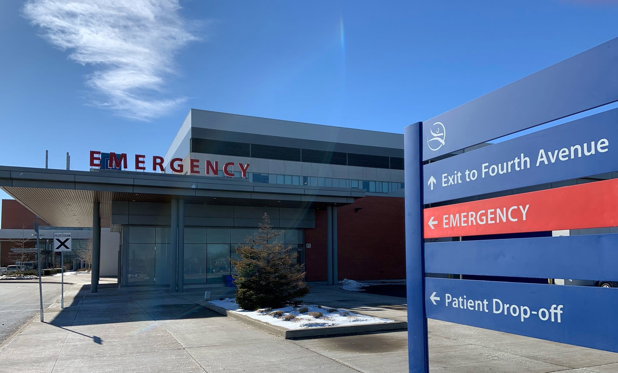 Exterior of a hospital emergency department. The word emergency is in large red letters on top of the building.