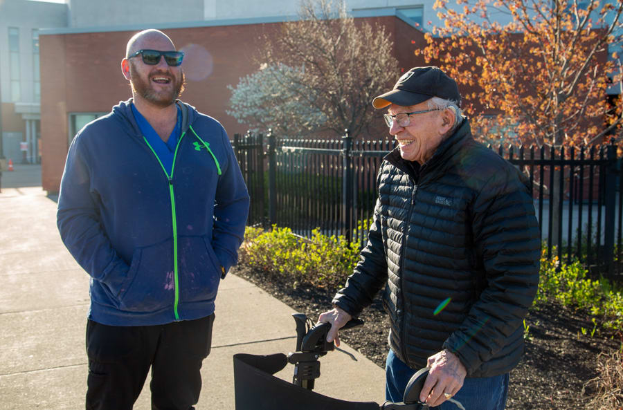 Environmental Services Aide Mark Ritchie shares a laugh with John Gerden. Gerden meets many friends from Niagara Health when he walks the path at the Marotta Family Hospital. He and Ritchie meet each other regularly on Gerden's walks.
