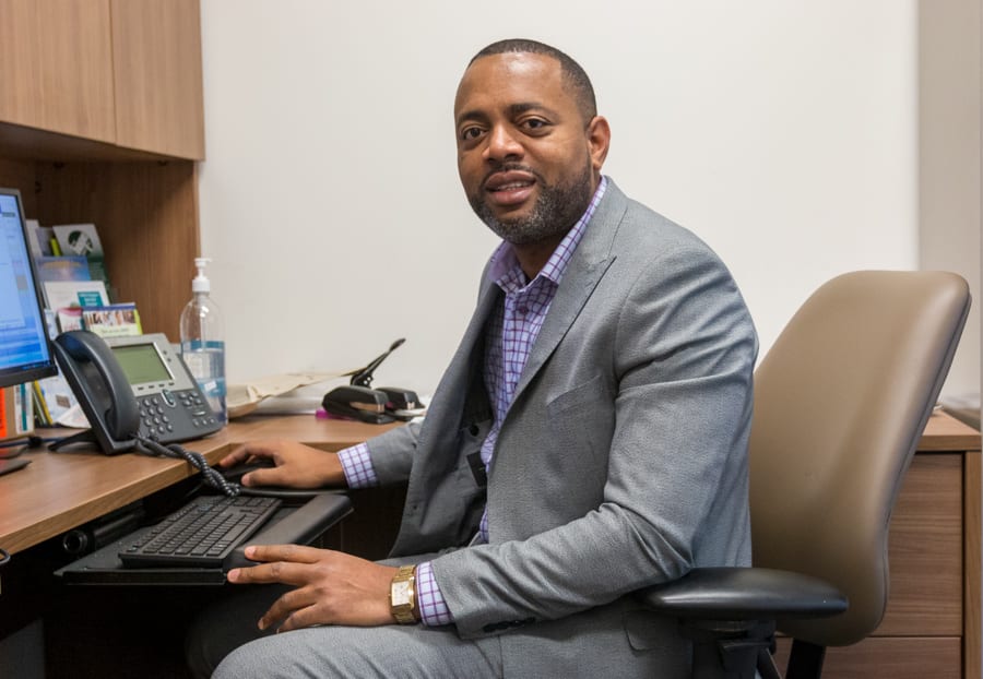 Dr. Victor Uwaifo sits at his desk in his hospital office. 