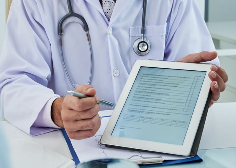 Physician holding a tablet