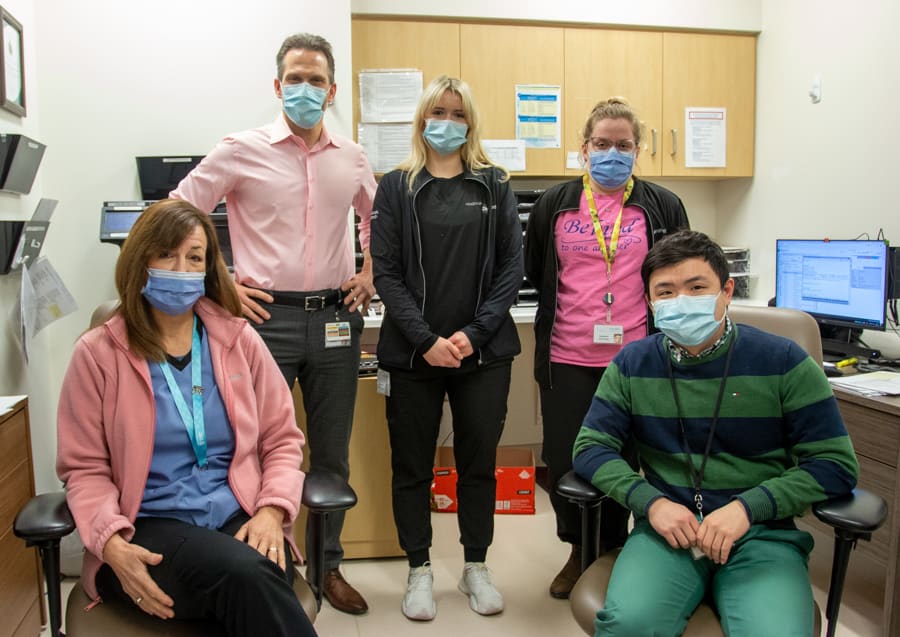 A group of people gather in an office in a hospital. They are Niagara Health's Thrombosis Service team